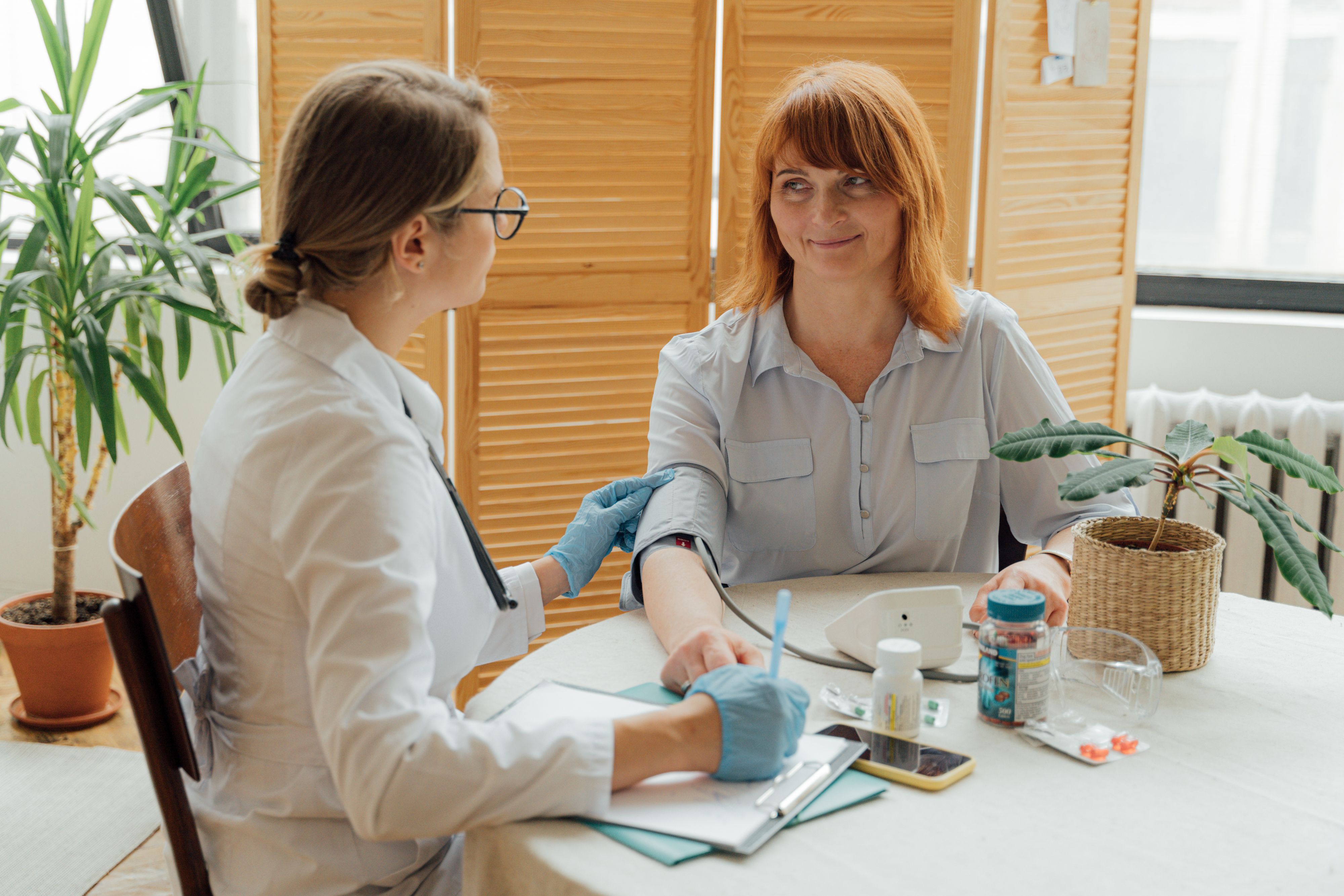 Doctor measuring a patient's blood pressure with a digital monitor