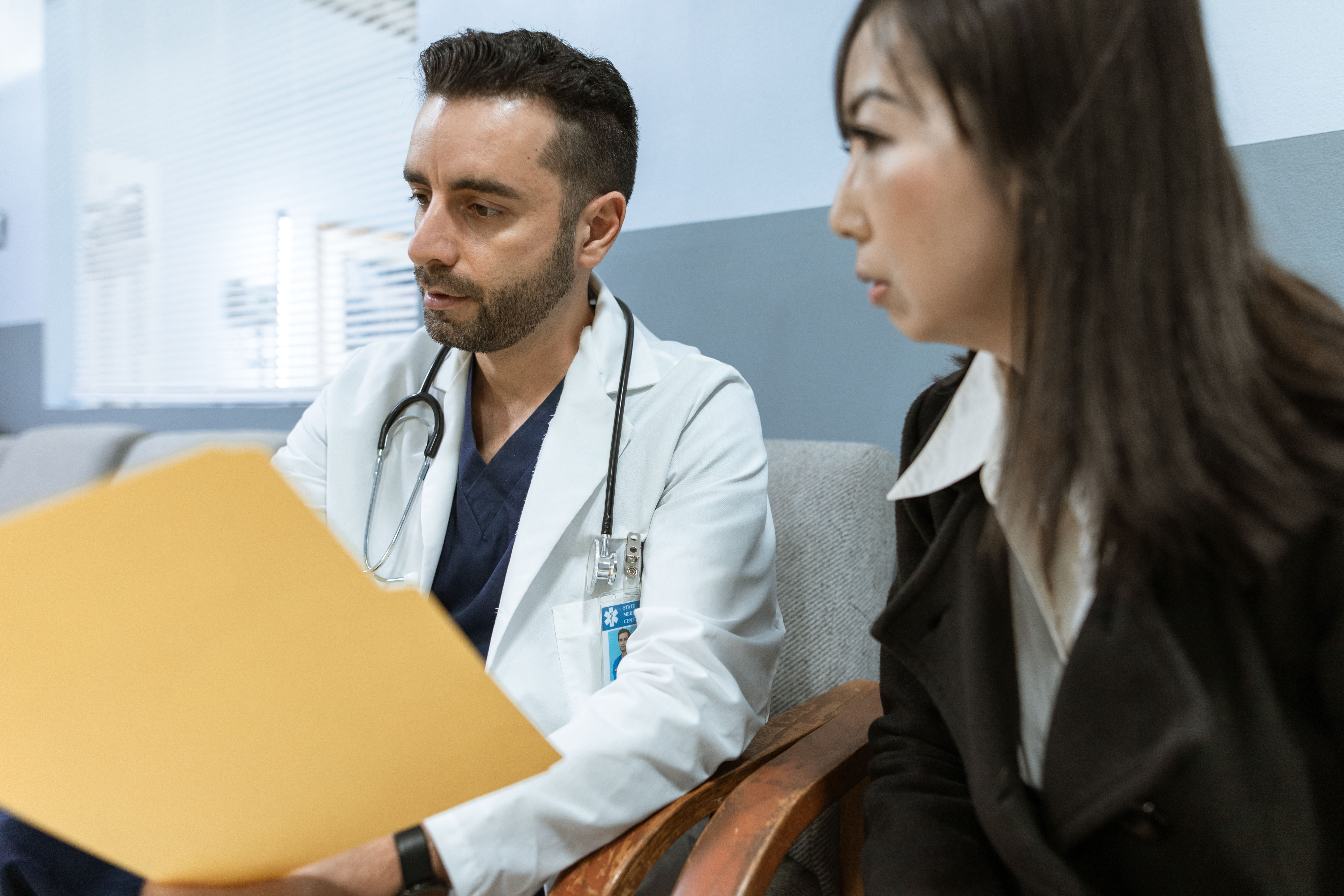 Male doctor talking with an adult patient