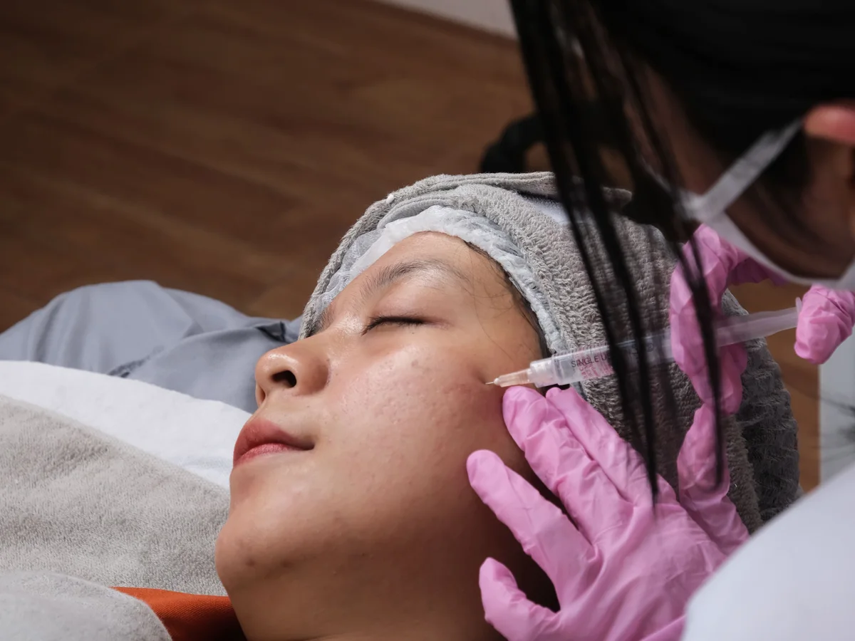 Skincare professional preparing a cosmetic treatment