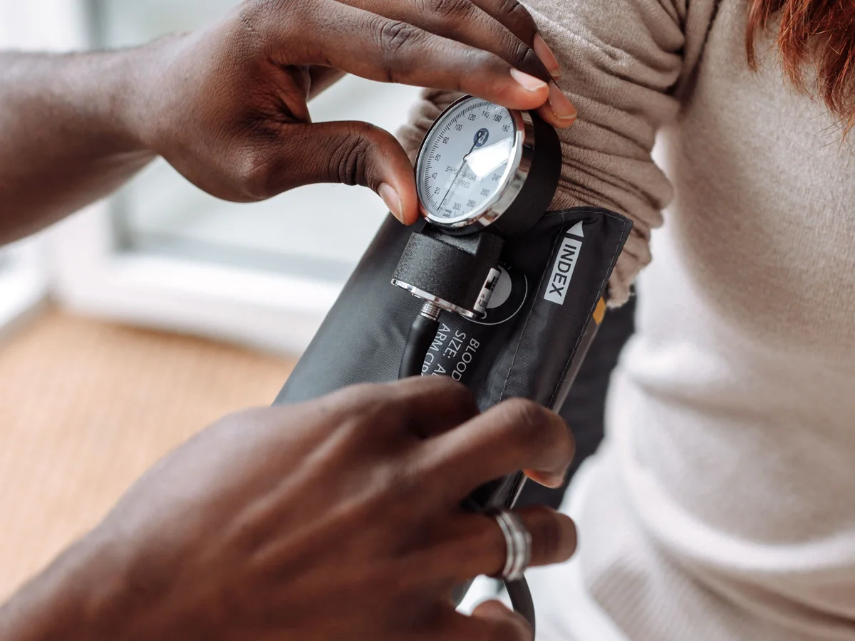 Clinician checking a patient's blood pressure